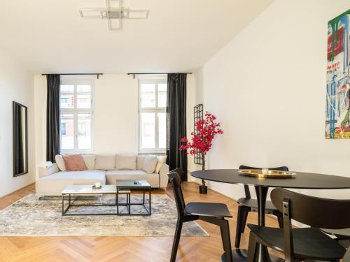 a living room with a couch and a table at Rochus Stylish Stays in Vienna