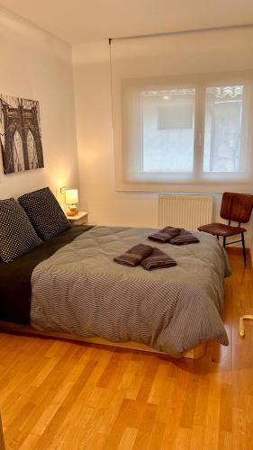 a bedroom with a large bed and a window at Rincón Estelles in Estella