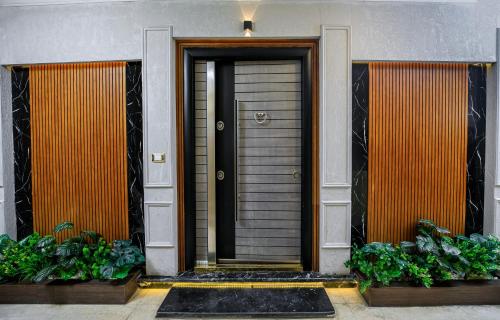a front door of a house with two plants at Piccolo Mondo Boutique Hotel in Cairo
