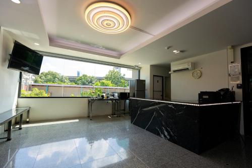a large room with a large window and a counter at Siam Rama9 Hotel in Amphoe Phra Khanong