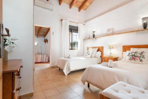 a bedroom with two beds and a living room at Son March I in Sa Pobla