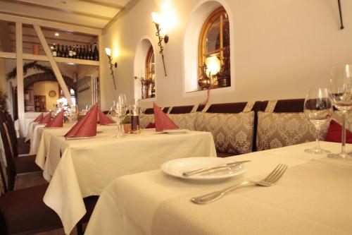 a row of tables in a restaurant with wine glasses at Fetzers Landhotel in Ingelheim am Rhein