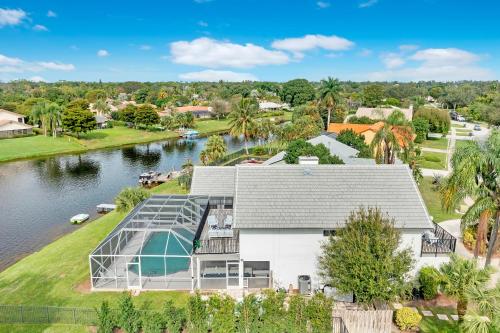 an aerial view of a house with a lake at Lake Luxe Equine, Waterfront, Screened-in Pool, Hot Tub - Lake Views! Hosted By Relaxtay in Wellington