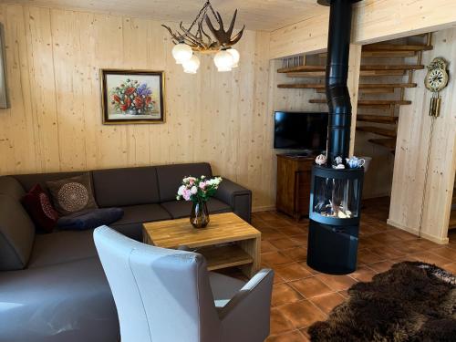a living room with a couch and a wood stove at Chalet in Hohentauern - Chalet Ana in Hohentauern