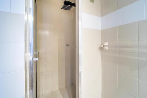 a shower with a glass door in a bathroom at Penthouse Chicalá Colombian Experience in Parque Virrey in Bogotá