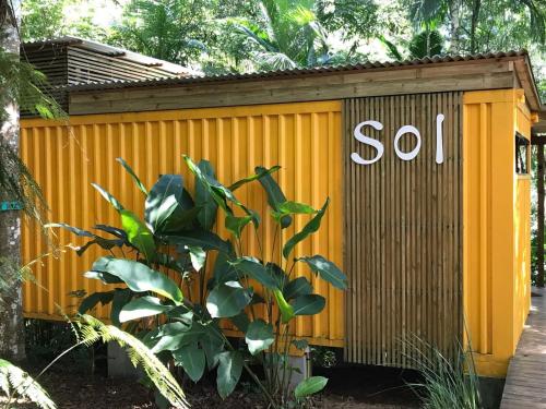 a yellow shed with the word soil written on it at Pousada Sitio Raizes in Siderópolis