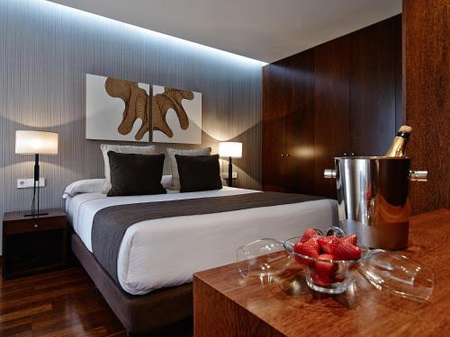 a hotel room with a bed and a bottle of champagne at Carris Cardenal Quevedo in Ourense
