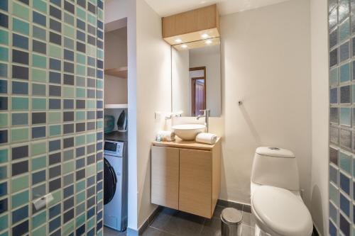 a bathroom with a toilet and a sink at Penthouse Chicalá Colombian Experience in Parque Virrey in Bogotá