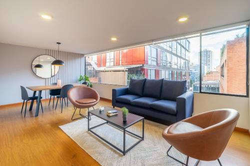a living room with a couch and a table at Penthouse Chicalá Colombian Experience in Parque Virrey in Bogotá