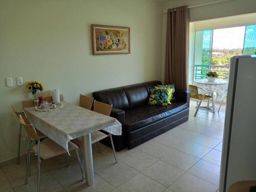 a living room with a leather couch and a table at Apartamento em Caldas Novas in Caldas Novas