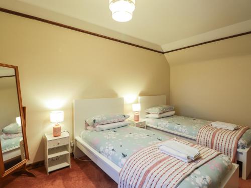 Postel nebo postele na pokoji v ubytování Rowan Tree House