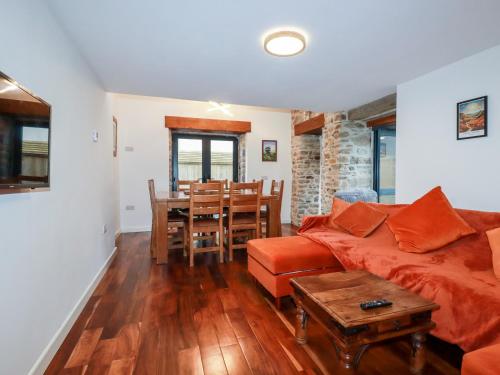 a living room with a couch and a table at The Old Cattle Barn in Launceston