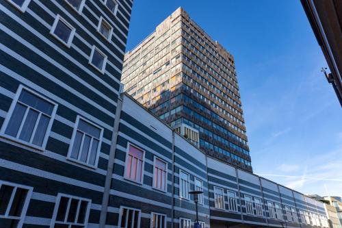 a tall building in front of a building at easyHotel Amsterdam Zaandam in Zaandam