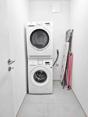 a washer and dryer in a small room at Downtown Dream 3,5BR with Balcony and Style BA31 in Zürich