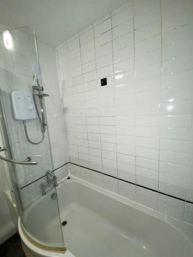 a white bathroom with a tub and a shower at Luxurious Suite: Nottingham Room in Nottingham