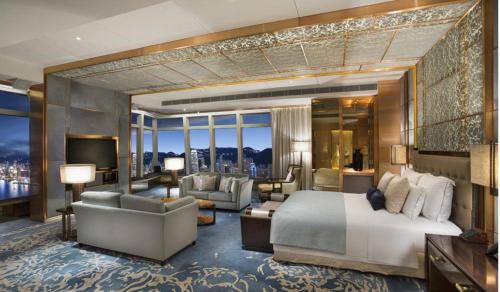a bedroom with a king sized bed and a living room at Ron ban in Dubai