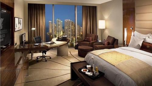 a hotel room with a large bed and a desk and a desk at Ron ban in Dubai