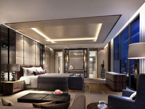 a bedroom with a bed and a living room at Ron ban in Dubai