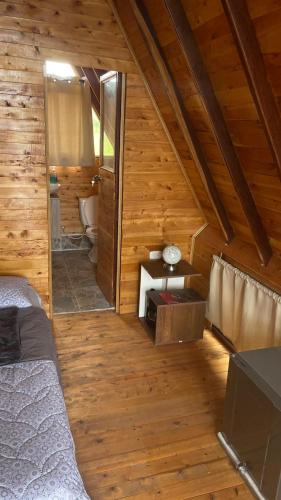 a room with a bed and a mirror in a cabin at Lago Cristal Chalets in Los Santos