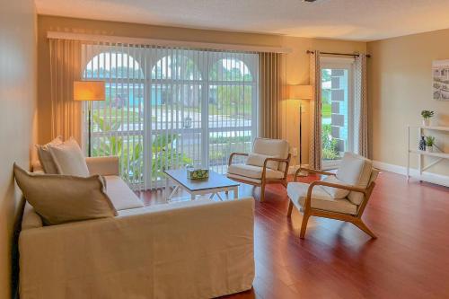 a living room with a couch and two chairs at A Sunshine State of Mind in North River Shores