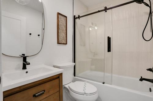 a bathroom with a sink and a toilet and a shower at Palmetto Paradise - B in St. Augustine