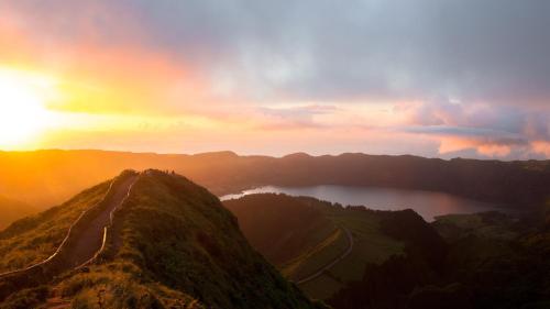 a sunset on top of a mountain with a lake at Alojamento CANTO NA RELVA in Ponta Delgada