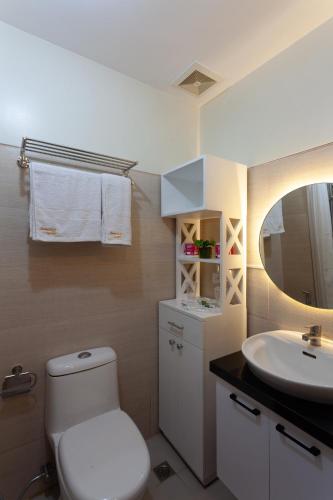 a bathroom with a white toilet and a sink at Room 2222 - Wind Residences, Tower 5, Tagaytay, PH in Tagaytay