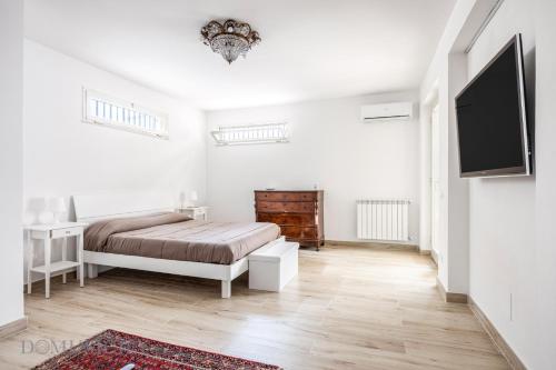 En eller flere senge i et værelse på La Dimora del Mare by Domus Sicily