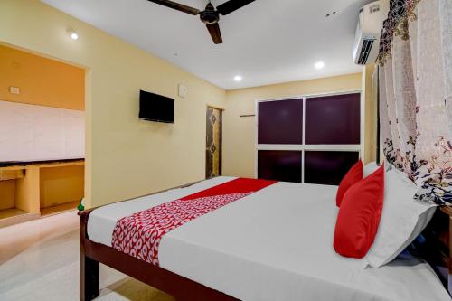 a bedroom with a bed and a large window at OYO AR Guest House in Visakhapatnam