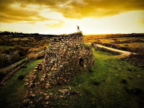 a person standing on top of a stone wall at Anninnìa Guest House B&B - GhiIarza in Ghilarza