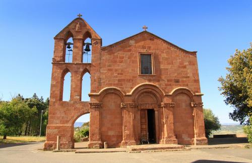 an old red brick church with a tower at Anninnìa Guest House B&B - GhiIarza in Ghilarza