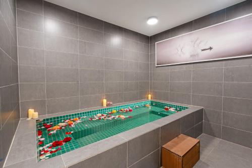 a bathroom with a swimming pool with flowers in it at TUI BLUE Nha Trang in Nha Trang