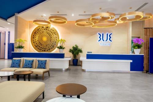 a lobby with couches and tables and a subucks sign at TUI BLUE Nha Trang in Nha Trang