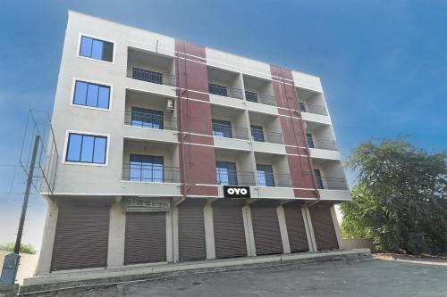 an apartment building with a qo sign on it at OYO Comfort lodging and boarding in Kalyan
