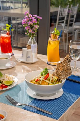 a table with a bowl of food and some drinks at TUI BLUE Nha Trang in Nha Trang