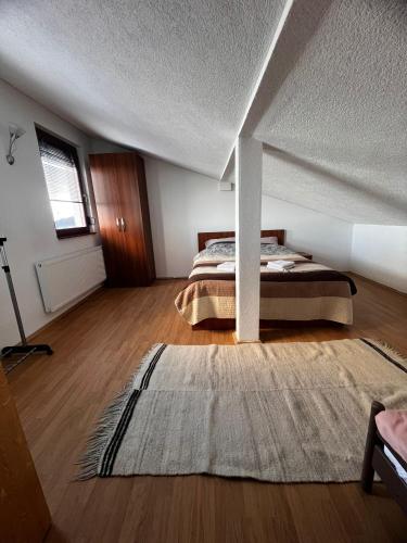 a bedroom with a bed and a rug at Lion King Bjelasnica in Bjelašnica