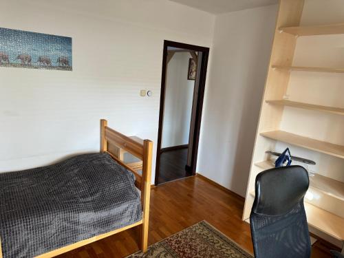 a room with a mirror and a chair and a staircase at Apartment C25 in Trnava