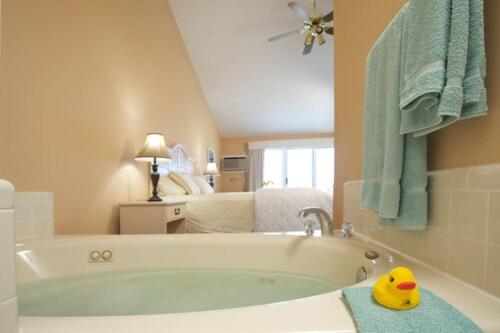 a bathroom with a bath tub with a rubber duck in it at Pointes North Beachfront Resort Hotel in Traverse City