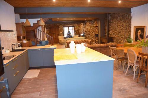 a kitchen with a island in the middle of a room at Casa Sapita in Villafranca del Bierzo