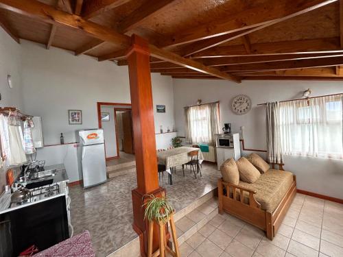 a living room with a couch and a kitchen at Terra Incognita in Ushuaia