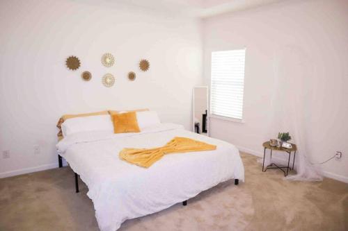a bedroom with a bed with a yellow blanket on it at NEW Charming Escape 3 BD King Suite East of Birmingham 