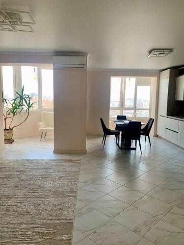 a living room with a table and chairs at River Apartments in Vinnytsya