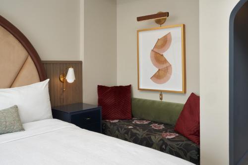 a hotel room with a bed and a couch at Hotel Vesper, Houston, a Tribute Portfolio Hotel in Houston