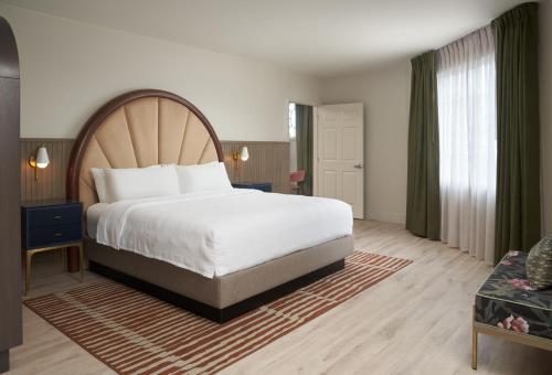 a hotel room with a large bed and a couch at Hotel Vesper, Houston, a Tribute Portfolio Hotel in Houston