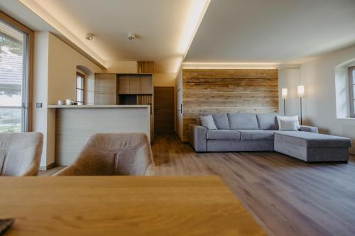 a living room with a couch and a table at WEIN DOMIZIL Zieger in Neuhaus am Klausenbach