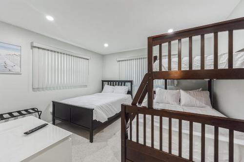 a bedroom with two bunk beds and a staircase at Riverside Retreat: Deck Bar, FirePit, Boat Parking in Fort Myers