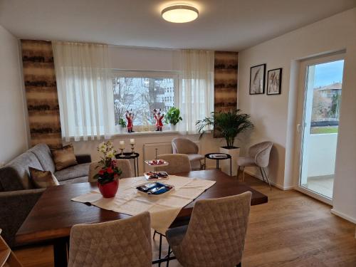 a living room with a table and a couch at Wohlfühlapartment 24 in Götzis