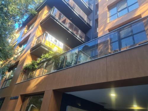 a building with glass balconies on the side of it at ERAS - Топ център Варна in Varna City