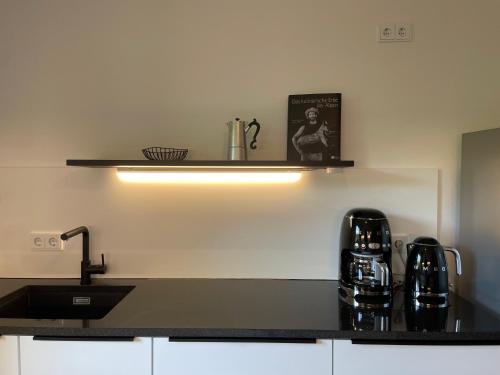 a kitchen with a sink and a counter top at Moderne Ferienwohnung mit Zugspitzblick in Grainau