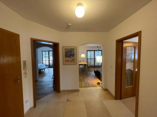 a hallway with two doors and a living room at Moderne Ferienwohnung mit Zugspitzblick in Grainau